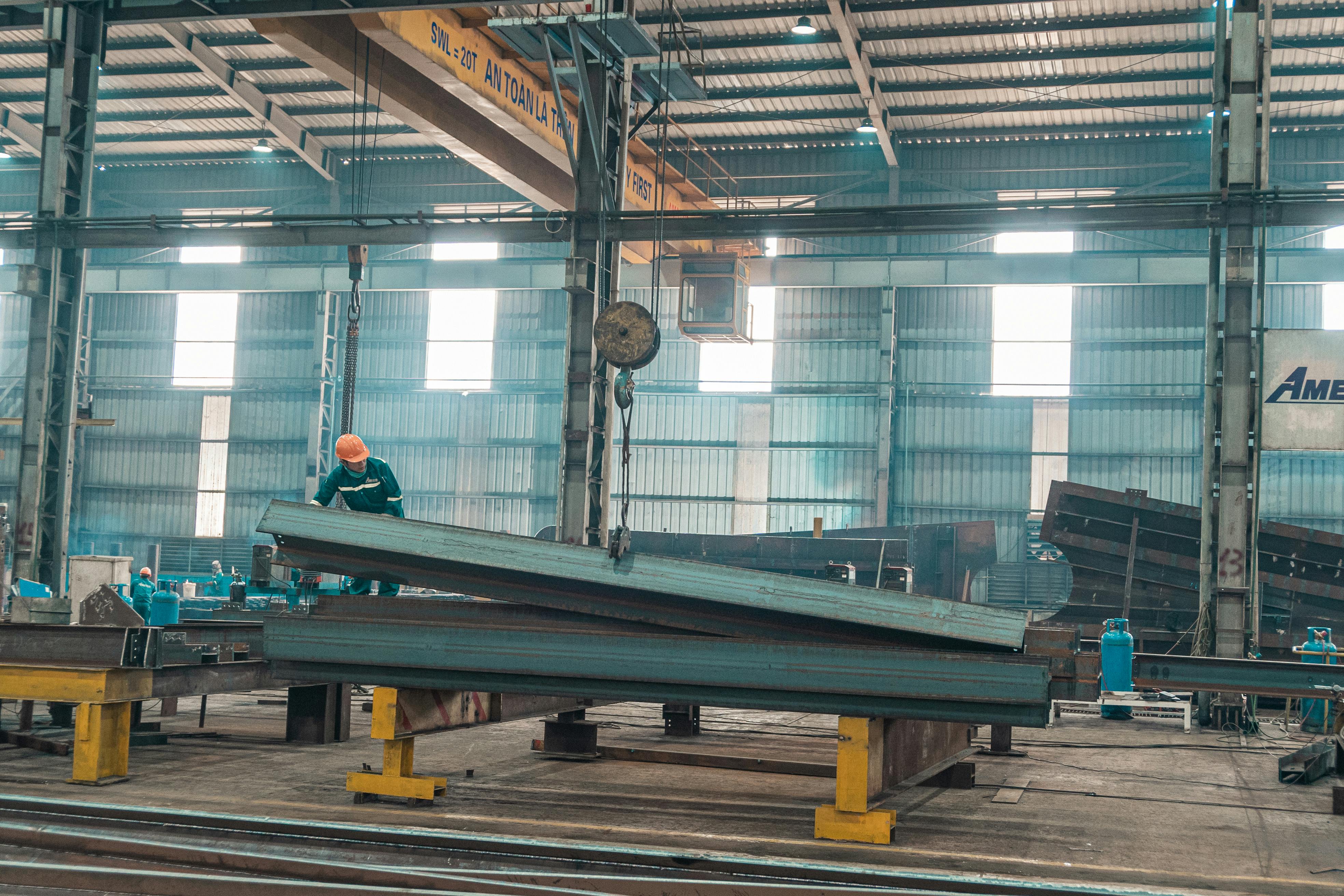 Steel manufacturing facility in development phase with construction cranes